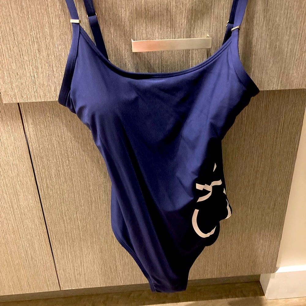 Navy one piece Calvin Klein bathing suit with white CK on the front.